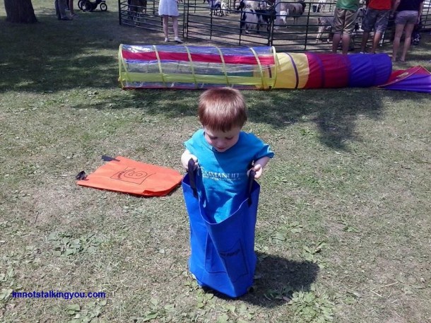 Trying to master the sack race.  He is winning because he is the only one racing.