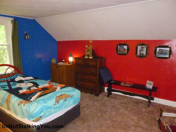 Finished bedroom showing bench and train pics.