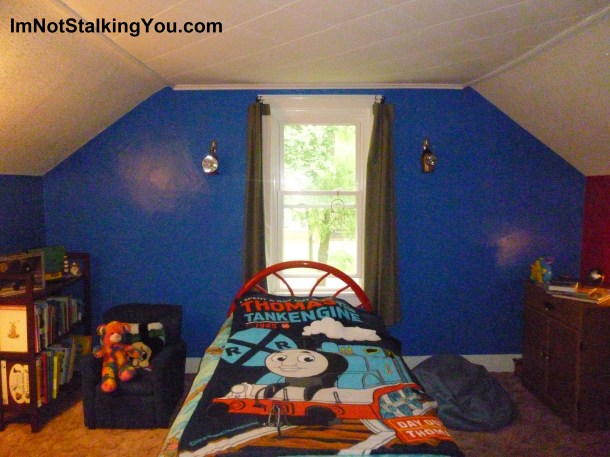 Finished bedroom with lanterns over twin-sized bed. I got those lanterns at a garage sale years ago.