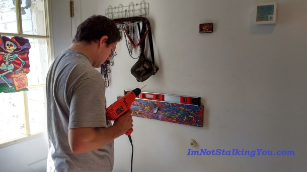 Manly husband with power tools doing installation. Ahr, ahr, ahr. Now, where did we leave those studs???